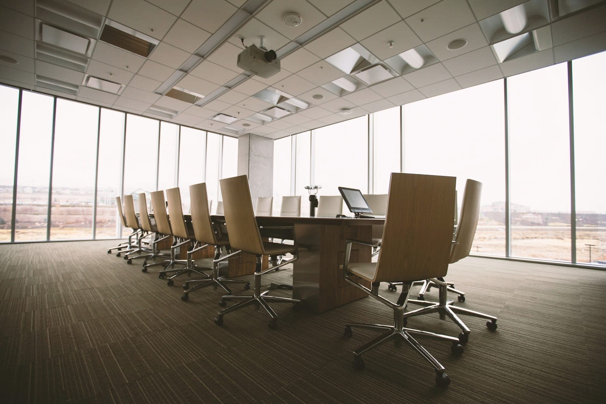 An empty boardroom with a long wooden table