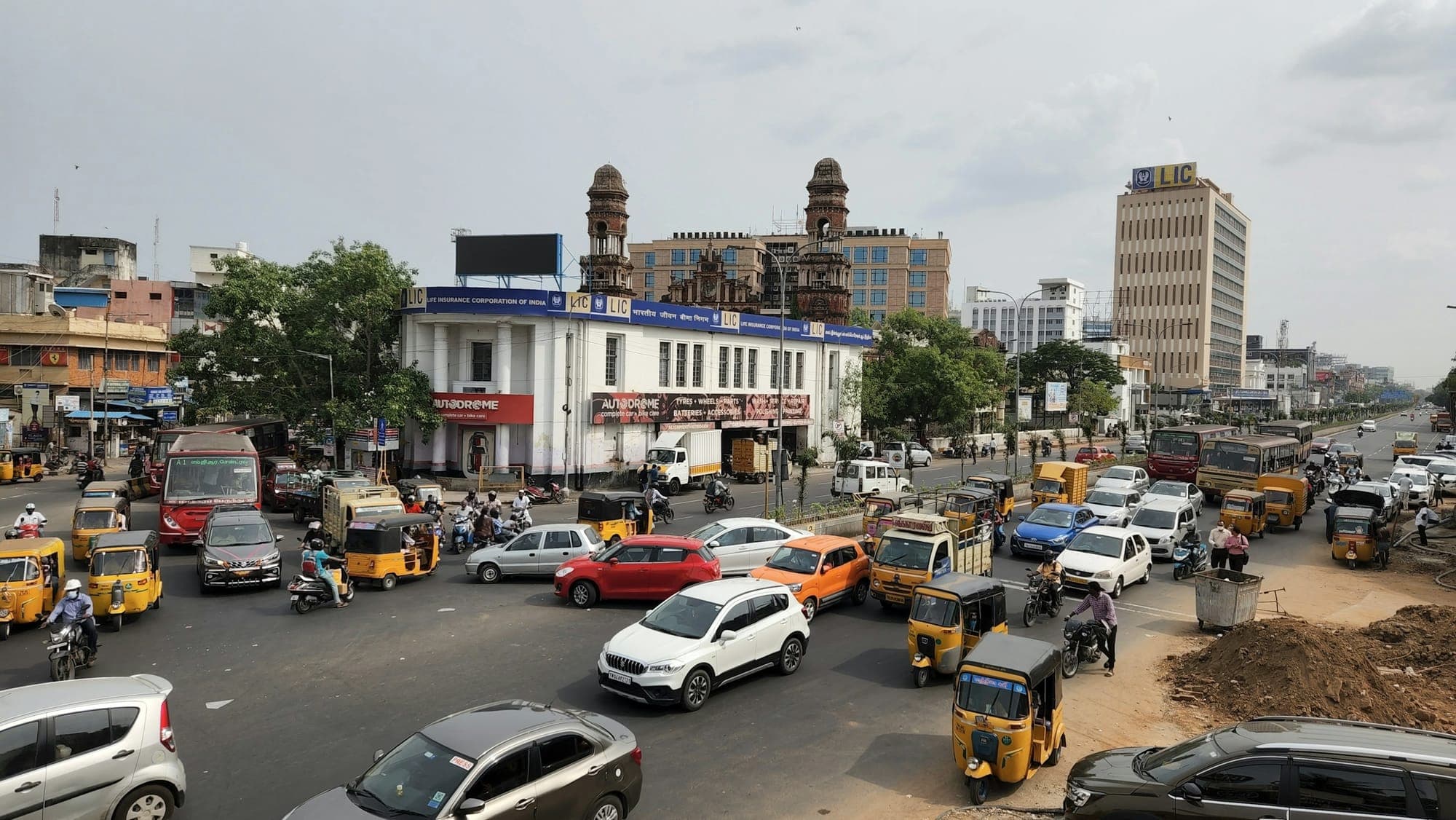 Cars and auto-rickshaws on a busy city road in India