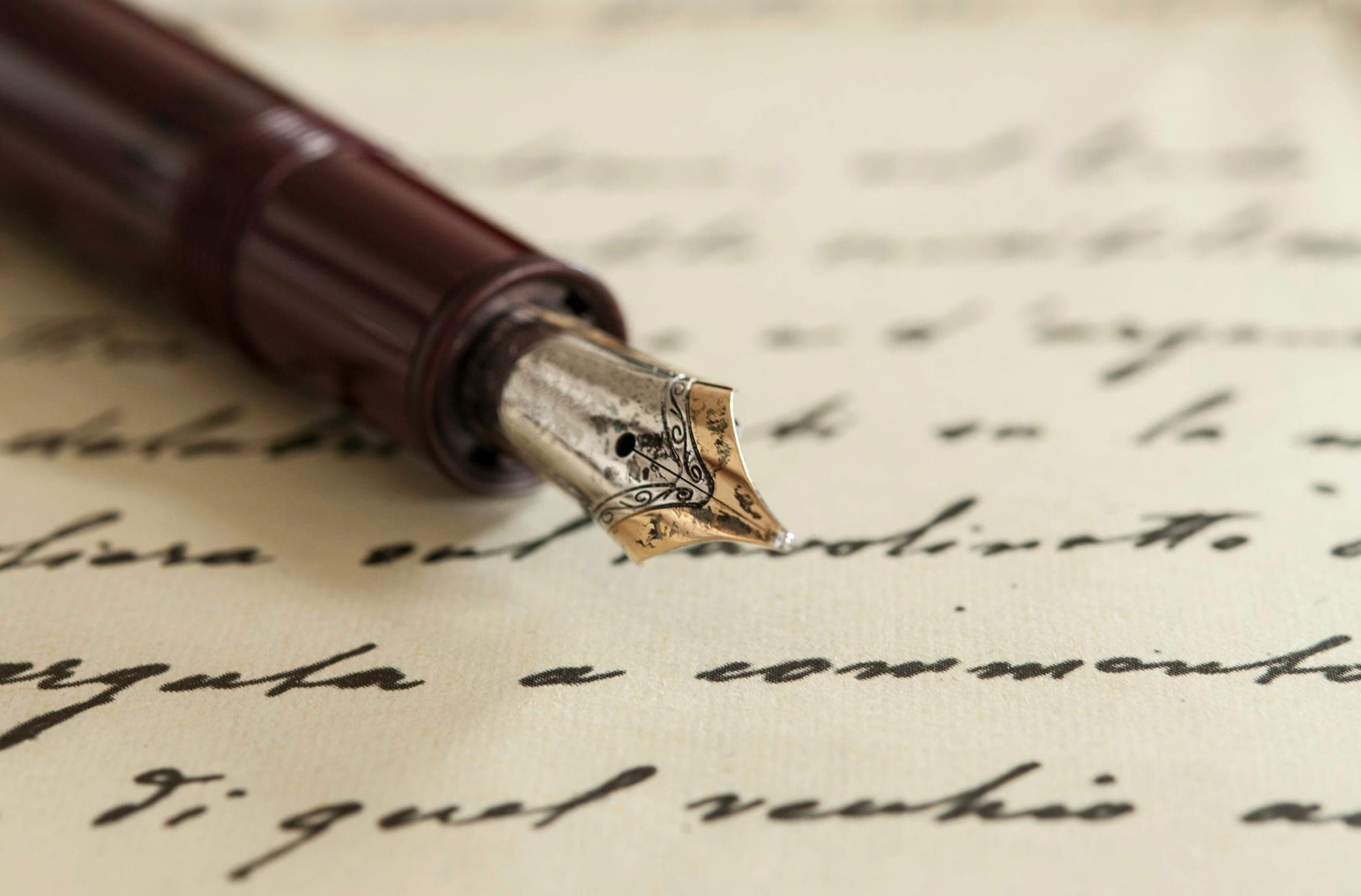 A fountain pen resting on a handwritten page