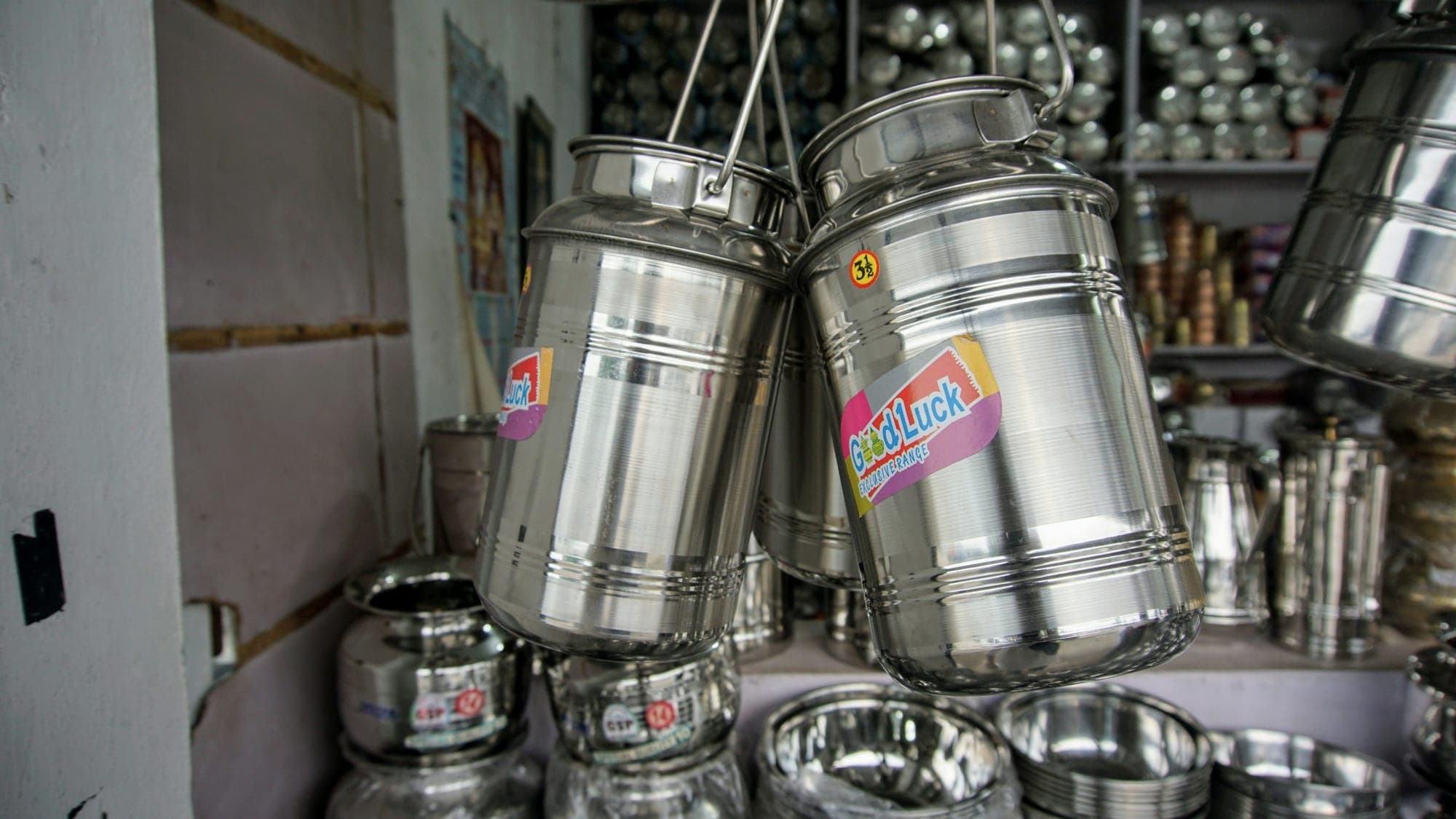 Stainless steel containers hanging in a shop