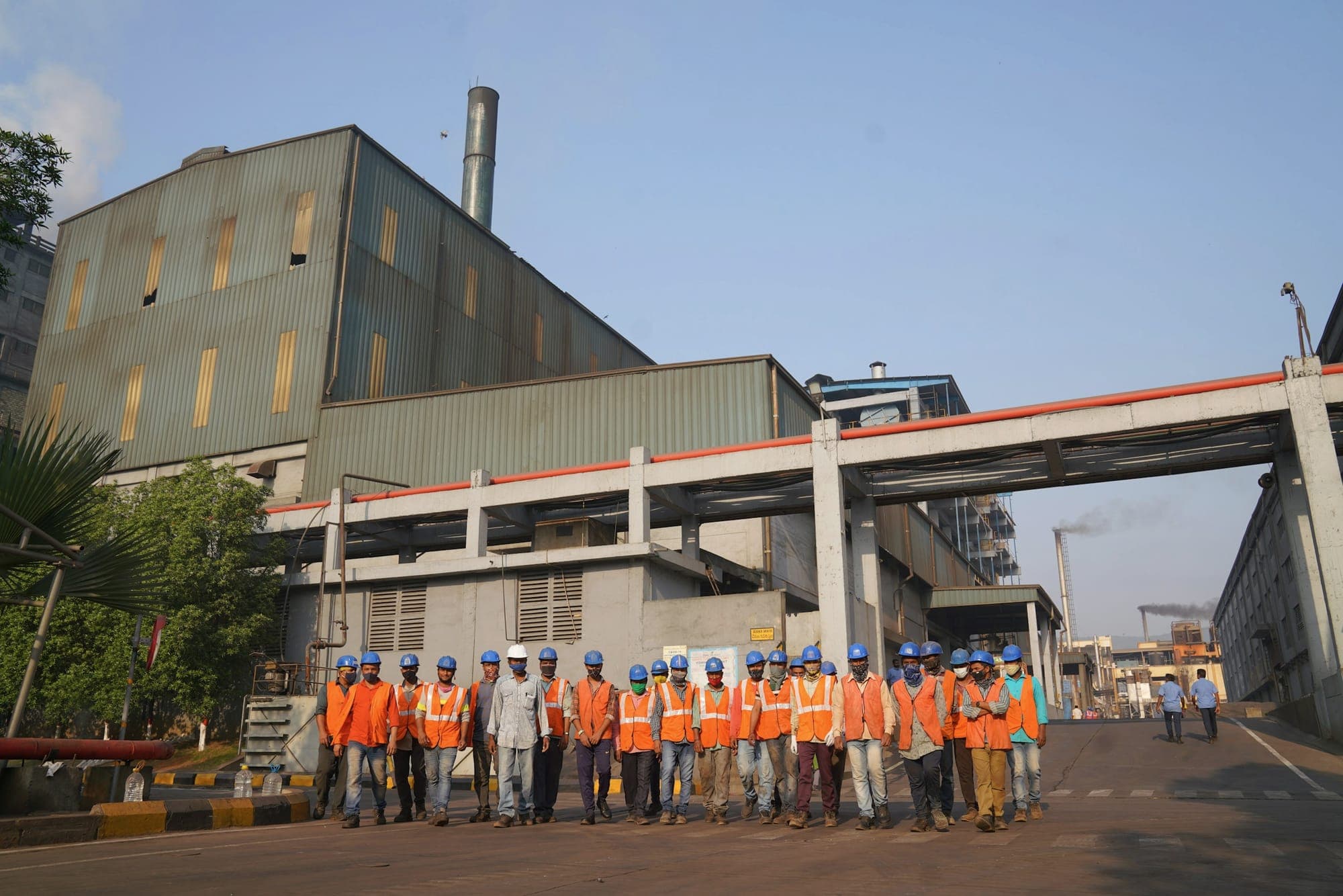 Workers in safety vests outside an industrial plant in Hyderabad